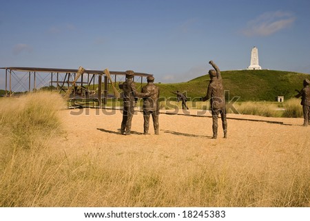 A bronze statue commemorating the first powered airplane flight by the Wright Brothers
