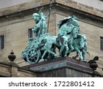 Bronze statue on a public building. The green patina sculpture of a woman in a chariot at the old Wayne County Building, Detroit, Michigan.                      