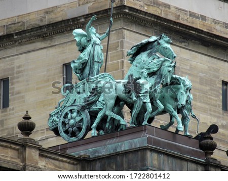 Bronze statue on a public building. The green patina sculpture of a woman in a chariot at the old Wayne County Building, Detroit, Michigan.                      