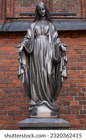 Bronze statue of Virgin Mary Immaculate outside of the Cathedral Basilica of apostles St. Peter and St. Paul of Kaunas, Lithuania