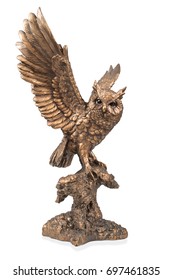 A bronze statuette of a flying owl with flapping wings isolated on white background