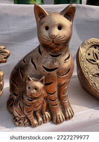 Bronze-finished ceramic cat and kitten lanterns with decorative cut-outs.
