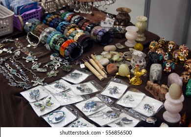 Brooches, figurines and accessories made from semi-precious stones on the market - Shutterstock ID 556856500