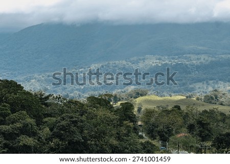 Brooding Arenal Volcano Casts Its Shadow Over Costa Rica's Glowing Emerald Hills