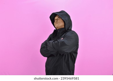 brooding asian man wearing black jacket - Shutterstock ID 2395469581