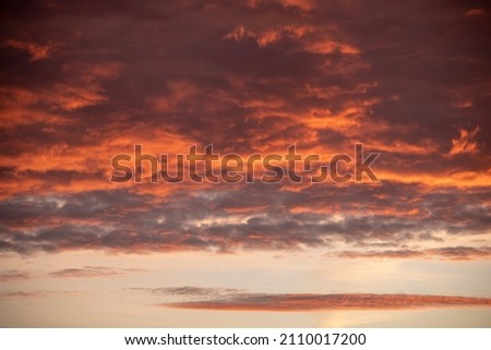 brooding burning clouds at sunset