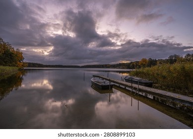 Brooding clouds form a powerful canopy over the somber water. A Scene of Sublime Isolation.