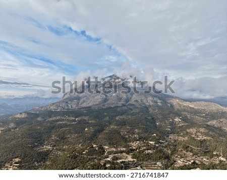 Brooding Peak Wrapped In Low Clouds Above Terraced Slopes And Scattered Farmhouses, Earthy Tones And Textured