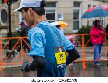 Brookline, Mass./US-April 16 2018. A Runner Runs In The Heavy Rain During 2018 Boston Marathon, Striving For The Last Few Miles To The Finish Line. 