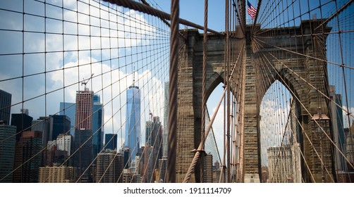 Brooklyn bridge american flag above bridge cables and stones. Brooklyn, New-York, United States - Powered by Shutterstock