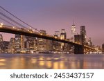 Brooklyn Bridge and Lower Manhattan skyline at dawn, New York City, New York, United States of America, North America