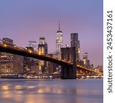 Brooklyn Bridge and Lower Manhattan skyline at dawn, New York City, New York, United States of America, North America