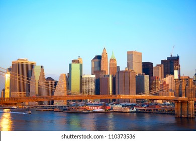 Brooklyn Bridge And Lower Manhattan Skyline At Sunrise In New York City