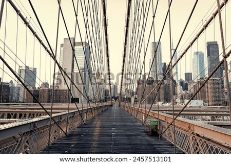 Similar – Image, Stock Photo Brooklyn Bridge over river against city in evening