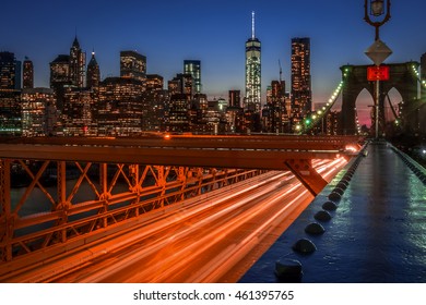 Brooklyn Bridge At Night With Light Trails Formed By The Moving Cars