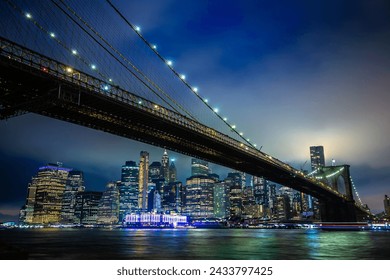 Brooklyn Bridge and panoramic night view of downtown Manhattan after sunset in New York City, USA - Powered by Shutterstock