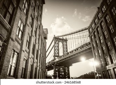 Brooklyn Bridge Seen Among City Buildings At Night.