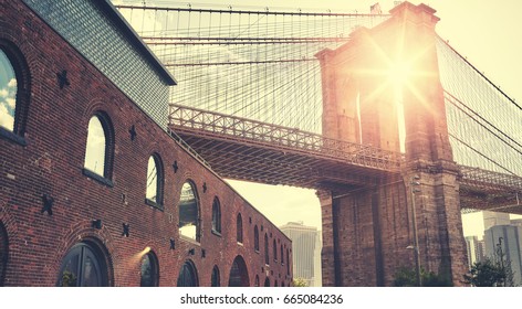 Brooklyn Bridge at sunset with lens flare, color toning applied, New York City, USA. - Powered by Shutterstock