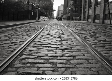Brooklyn cobblestone street with train tracks.