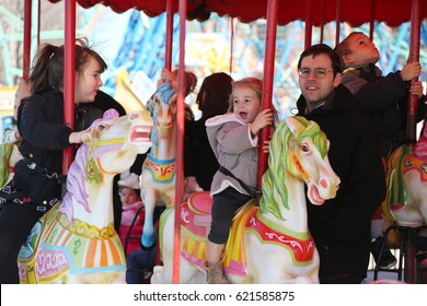 BROOKLYN, NEW YORK - APRIL 13, 2017: Children and adults ride Coney Island carousel in Luna Park at Coney Island Boardwalk in Brooklyn. 