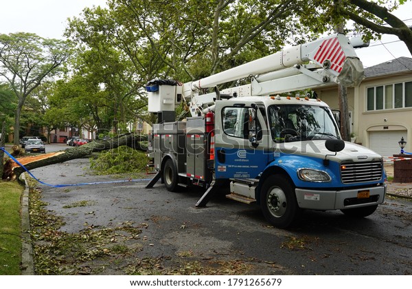 BROOKLYN, NEW YORK - AUGUST 6,\
2020: Con Edison repair crew restores power and clears street the\
aftermath of severe weather as tropical storm Isaias hits New York\
City 