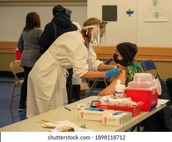 BROOKLYN, NEW YORK - JANUARY 19, 2021: A Woman Receives A Dosage Of The COVID-19 Vaccine At  Abraham Lincoln Hill School Vaccination Site In Brooklyn, New York