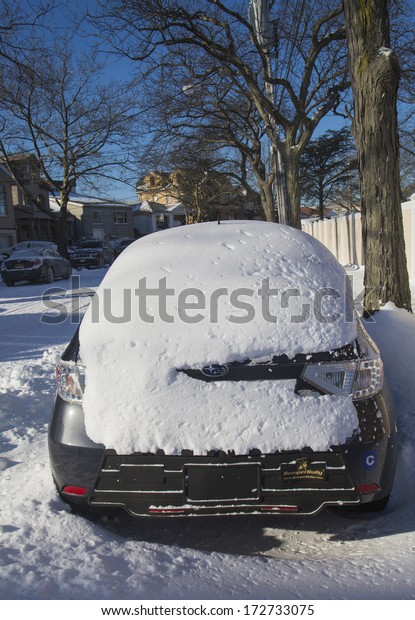 BROOKLYN, NEW YORK - JANUARY 22: Car under snow on\
January 22, 2014 in Brooklyn, NY after massive Winter Storm Janus\
strikes Northeast. Foot of snow hits NYC as Northeast reels from\
Winter Storm Janus