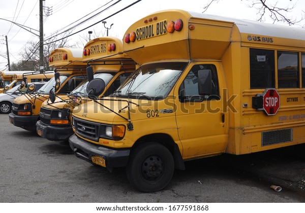BROOKLYN, NEW YORK - MARCH 19, 2020: School\
buses parked on the yard in Brooklyn, NY after New York City closed\
down the public school system to stop the spread of the coronavirus\
(COVID-19)