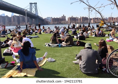 Brooklyn, New York  United States - March 22 2021: People Remove Face Masks Against  Domino Park Rules  During Coronavirus Pandemic On First Sunny Spring Day Of The Year