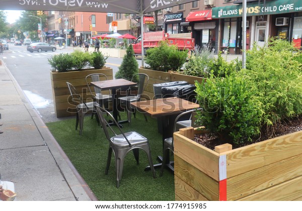 Brooklyn, New York / United States - July 11\
2020: Restaurant outdoor seating on city street during Coronavirus\
pandemic shutdown