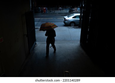 Brooklyn, New York USA 4.26.2022: Person Holding Umbrella Walks Into The Avenue J 