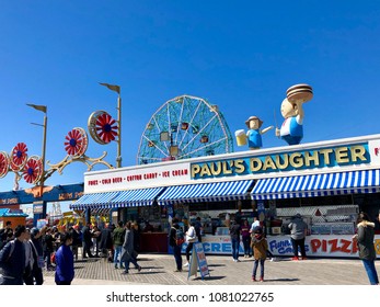 BROOKLYN, NY - APRIL 22, 2018: People Pass By The Famous Paul’s Daughter Fast Food Store In Brighton Beach Promenade Near The Deno’s Wonder Wheel Amusement Park.