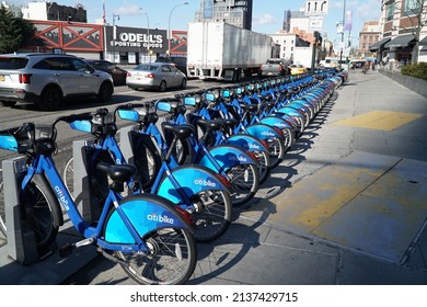 Brooklyn, NY; Circa 2022: Citibike Ride Share Bicycle Rack Outside On Sidewalk During Morning Commute. New York Commute Traffic Passes By On  Avenue In Background