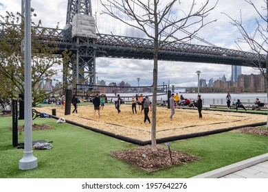 Brooklyn, NY - USA - April 17, 2021: A View Of People Enjoying  A Game Of Volley Ball At Domino Park's Beach Volleyball Court. A Public Park Located On The East River In Williamsburg.
