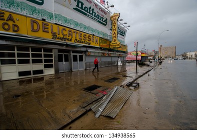 BROOKLYN, NY/USA - OCTOBER 30: A Man Walks In Front Of Nathan's Famous Hot Dog Stand Amid Damage From Hurricane Sandy On October 30, 2012 In The Coney Island Section Of Brooklyn.