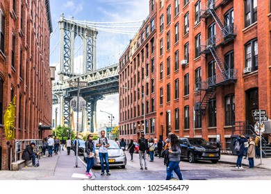 Brooklyn, USA - October 28, 2017: View Of Under Manhattan Bridge In Dumbo Outside Exterior Outdoors In NYC New York City, Brick Building, Blue Sky, People Busy Crowd Walking, Japanese Store