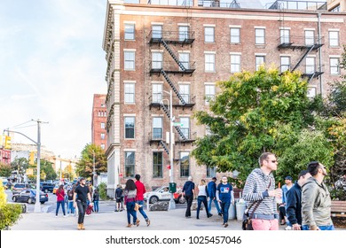 Brooklyn, USA - October 28, 2017: Outside outdoors in NYC New York City Brooklyn Bridge Park with many crowd of people walking by brick brown building on Furman street