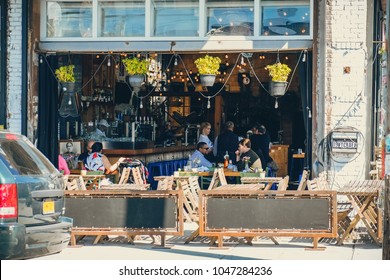 Brooklyn, USA - October 4, 2017: Bushwick Outside Exterior Outdoors In NYC New York City, People Sitting Eating In A Restaurant 