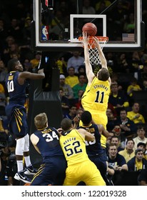 BROOKLYN-DEC 15: Michigan Wolverines Guard Nik Stauskas (11) Dunks The Ball Past West Virginia Mountaineers Guard Eron Harris (10) At Barclays Center On December 15, 2012 In Brooklyn.