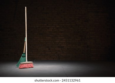 Broom and dust pan on the dirty dusty floor. Cleaning concept. - Powered by Shutterstock