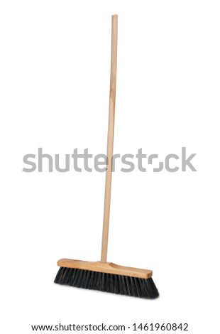Broom with long wooden handle isolated on white background. Cleaning equipment for housework