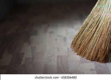 A broom stands on a wooden floor. Parquet board. New floor. Sweeping the floor. Broom
 - Powered by Shutterstock