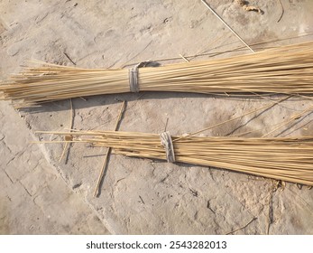 A broom of straw lies on the ground in the yard of a village house. Natural organic wooden broom. Cleaning tool for home. Handmade whisk sweeping broom for cleaning dustpan indoor-outdoor - Powered by Shutterstock