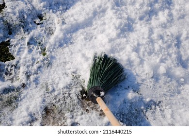 Broom for sweeping snow. Sweep the snow with a broomstick.