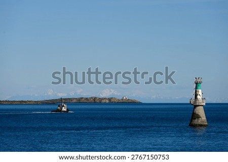 Brotchie Ledge Light, aid to navigation, ATON, small automated lighthouse in channel to Victoria harbor, tugboat heading out past Trial Islands Lighthouse in background
