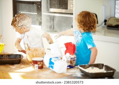 Brother, baking and flour with children fighting in the kitchen while making a mess of their home together. Cooking, recipe and ingredients with boy kids arguing about instructions in a house - Powered by Shutterstock