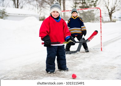 brother playing hockey in street
