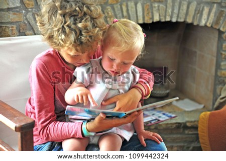 Similar – grandma reading a book to a child