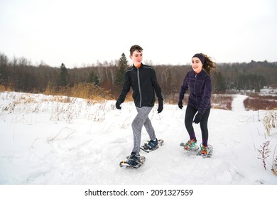 A Brother And Sister Child Hiking With Snowshoes Racket In Winter Day