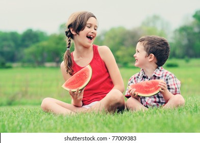 A Brother And Sister Eating Watermelon Together